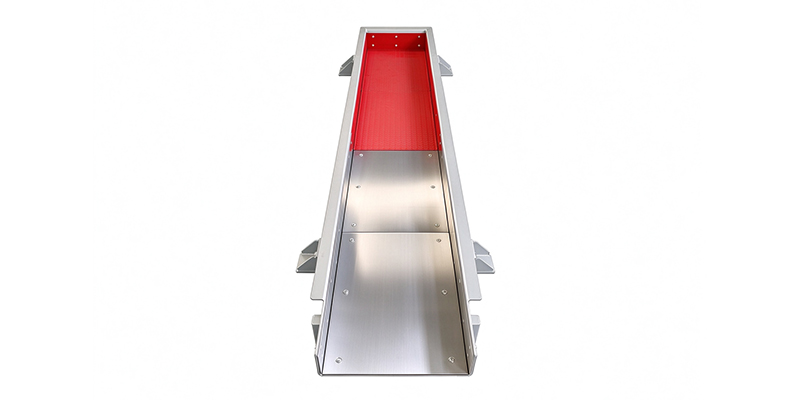 Internal view of trough vibrating feeder, red hardfaced impact liner and silver wear-resistant steel liner
